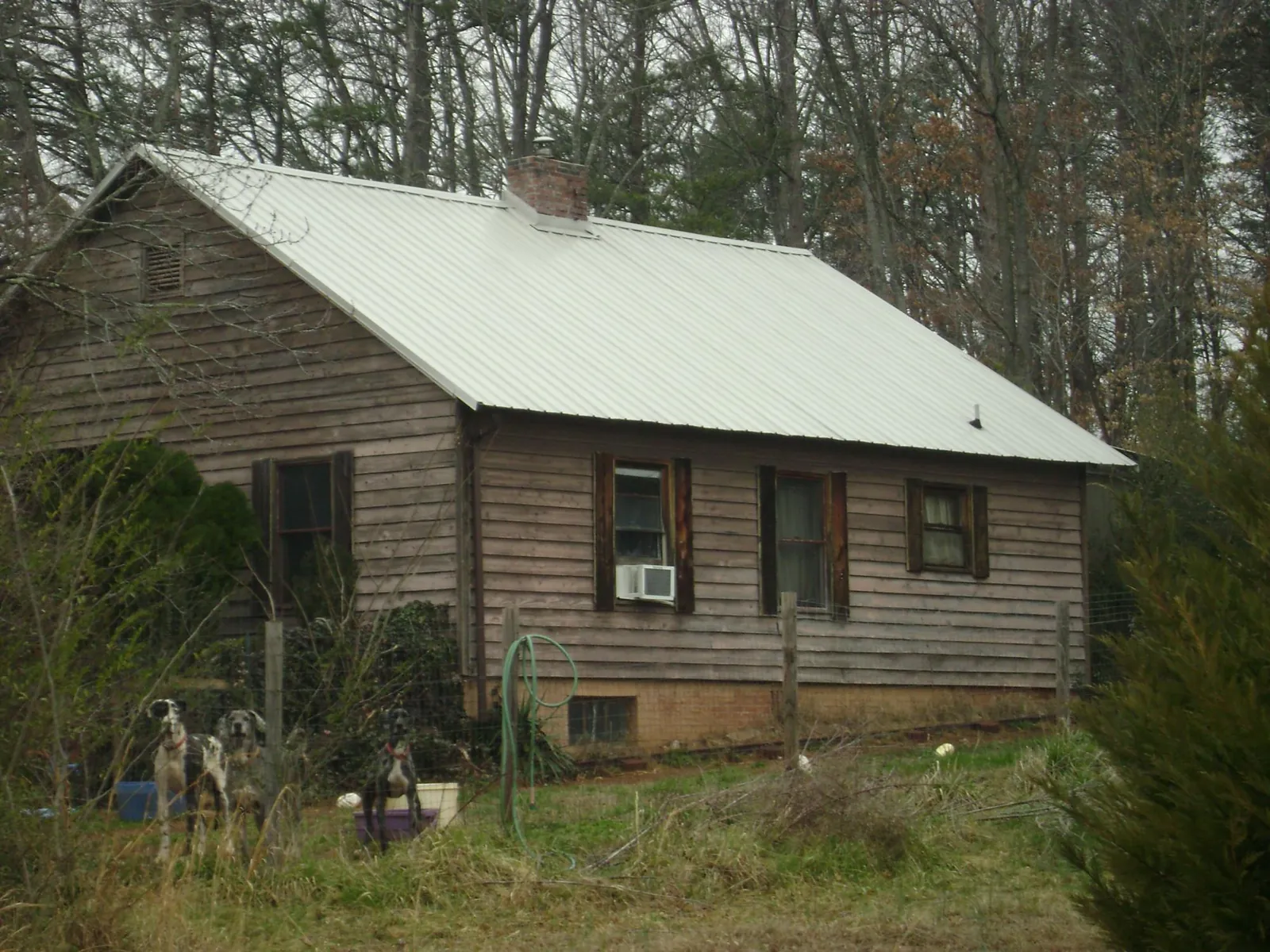 White metal roof on an old wood sided farmhouse, from a Metal Roof Installation job in Viewtown